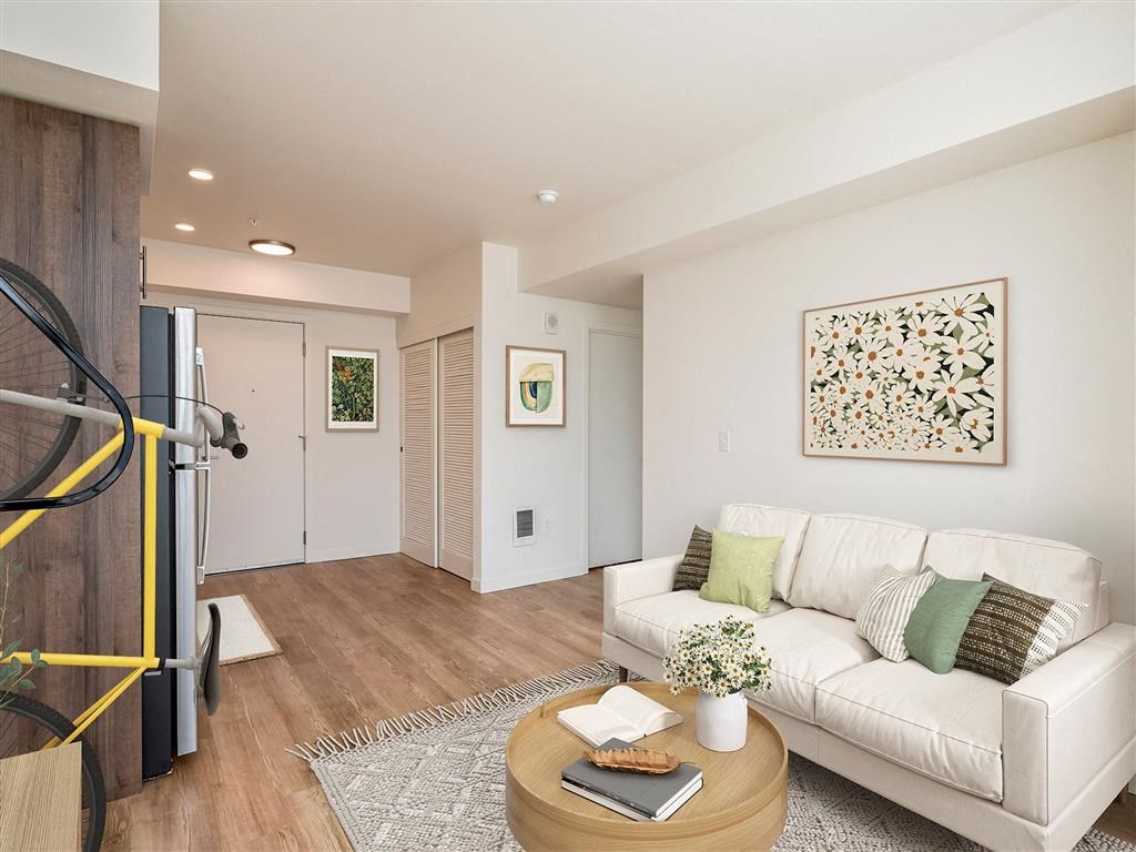 a living room with a couch and a table and a yellow bike