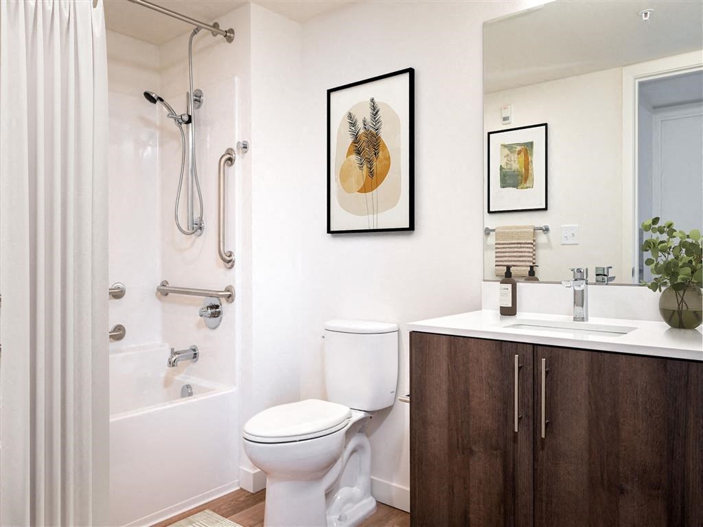 a bathroom with a toilet sink and shower and a mirror