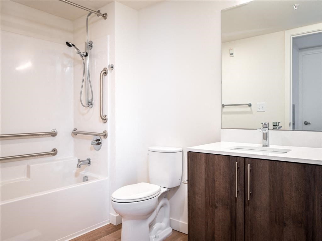 a bathroom with a toilet and a tub and a sink