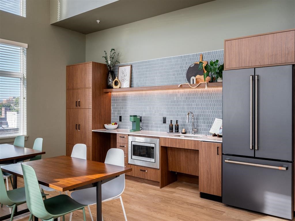 a kitchen and dining area with a table and chairs