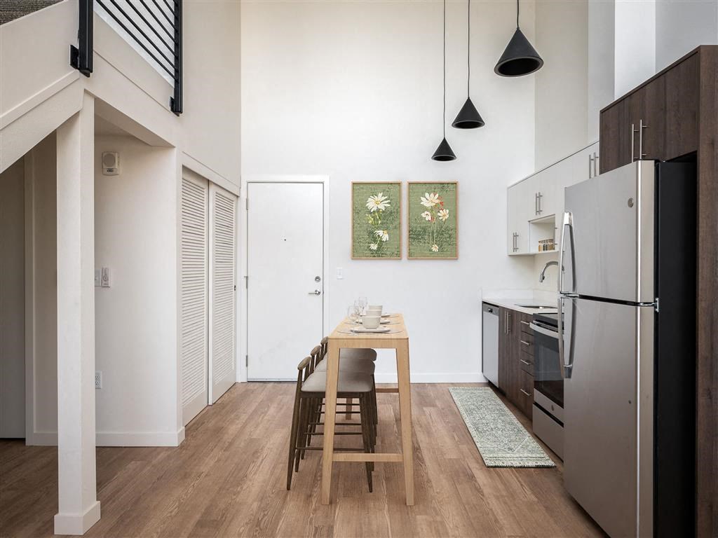 a kitchen with a wooden table and a refrigerator