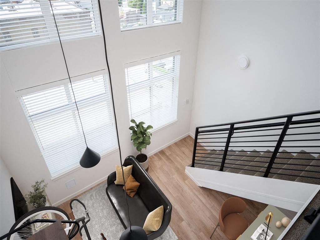 an overhead view of a living room with a bed and a futon