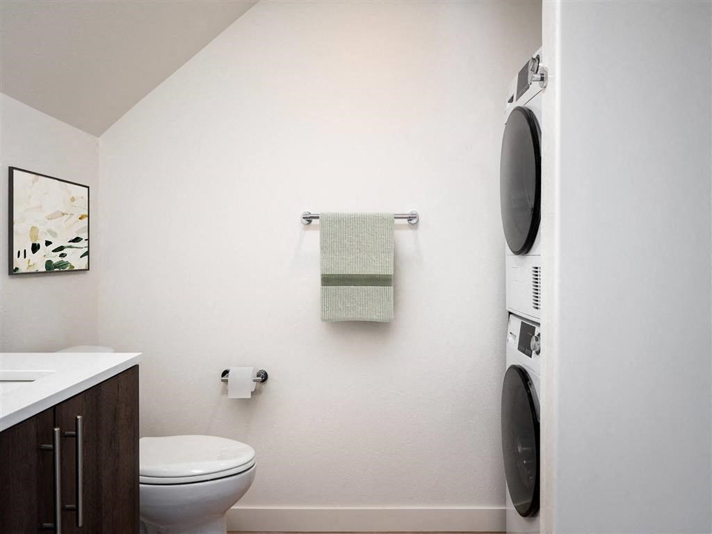 a small bathroom with a toilet and a washing machine
