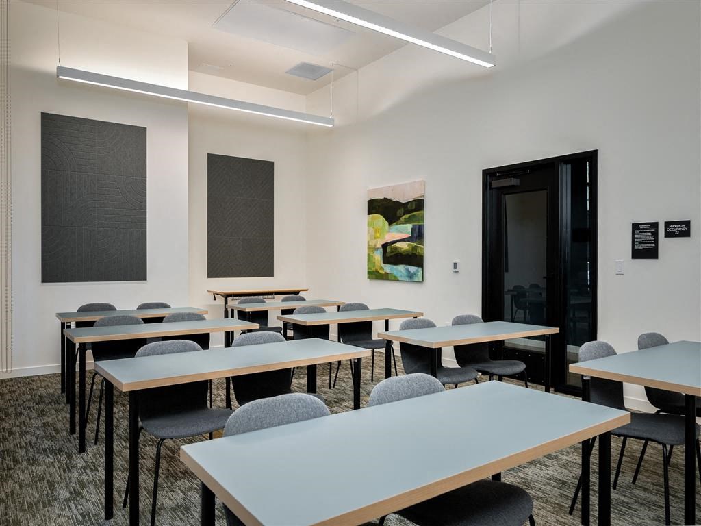 a classroom with tables and chairs and a door
