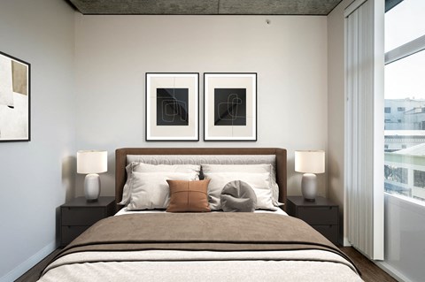 a bedroom with a bed and two pictures on the wall