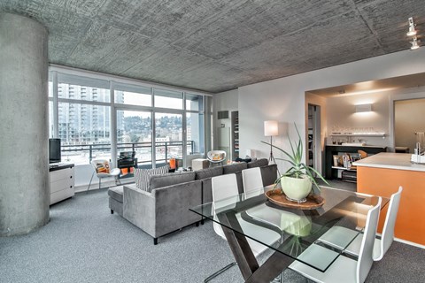 a living room with a glass table and a couch