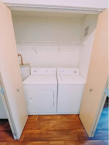 A small laundry room with a washer and dryer.