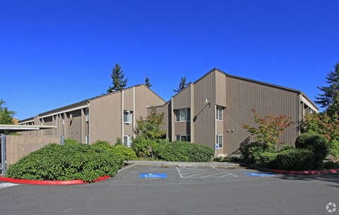 A large building with a parking lot in front of it.