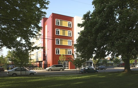 A red building with a tree in front of it.