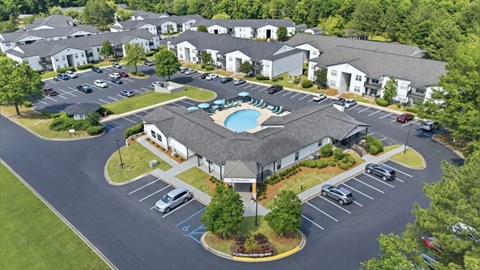 A large building with a pool in the middle of a parking lot.