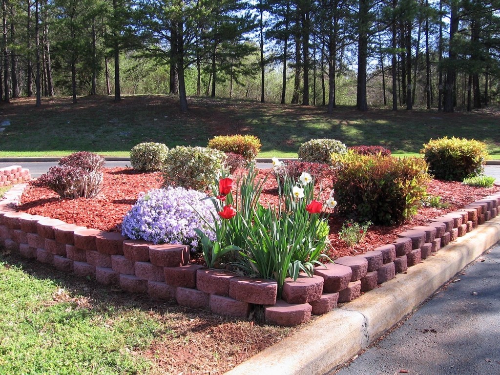 a beautiful spring garden in a brick containter at Village Square Apartments in Russellville, AL