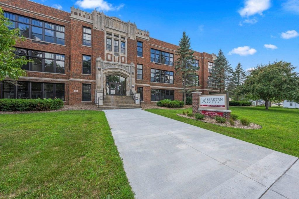 a large walkway leading up to the entrance of Spartan Lofts in Sparta, WI