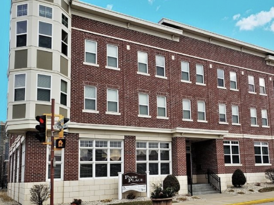 a large brick building with a sign in front of it
