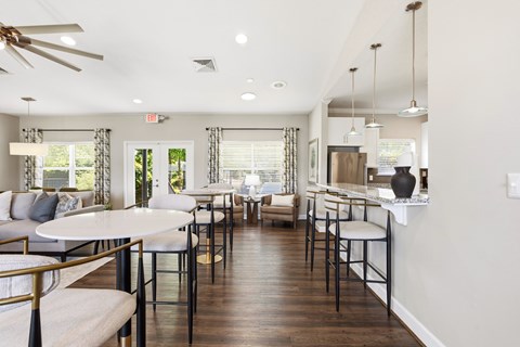 A well-lit, modern dining area with a white table and chairs.