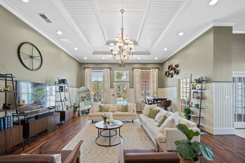 a living room with couches and a chandelier