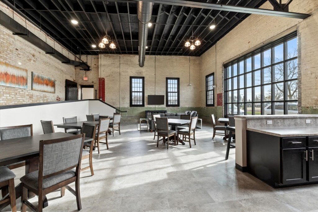 the large community room with ample seating at Brooke Street Lofts in Fond du Lac, WI