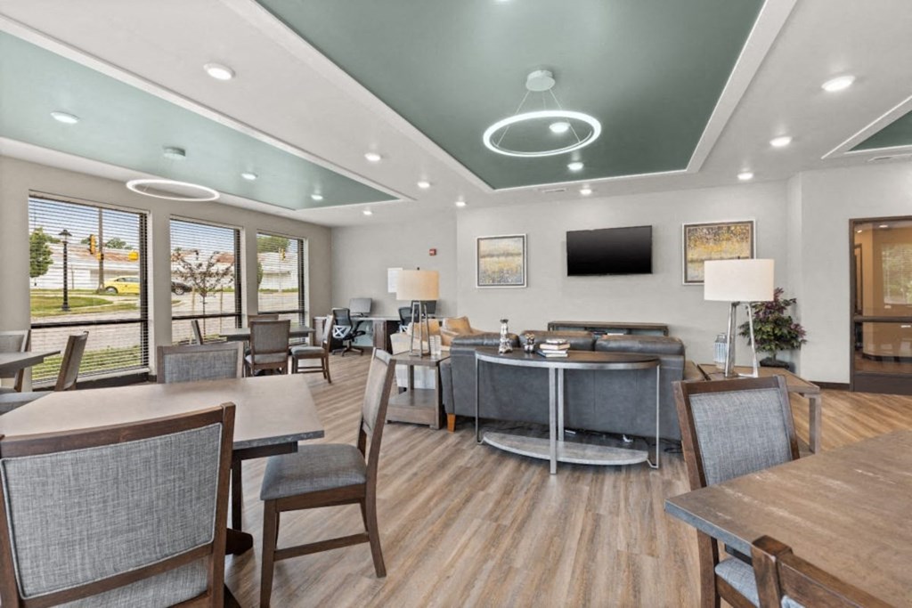 River Flats community room with tables, chairs, sofas, and TV