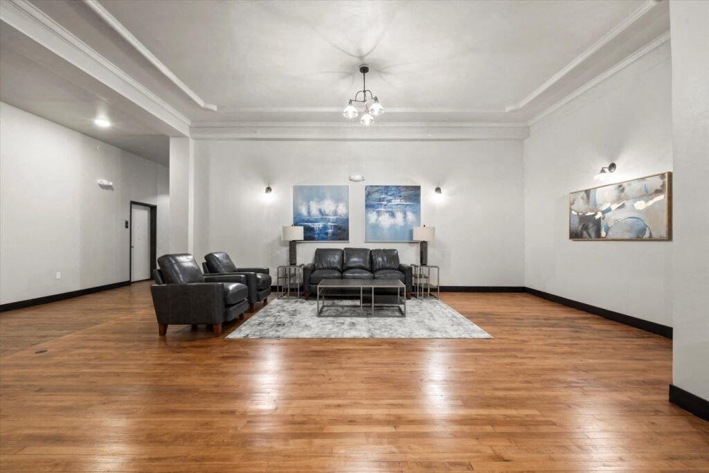 a lounge with arm chairs, a sofa, and coffee table at Brooke Street Lofts