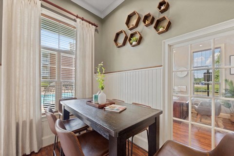 a dining room with a table and chairs