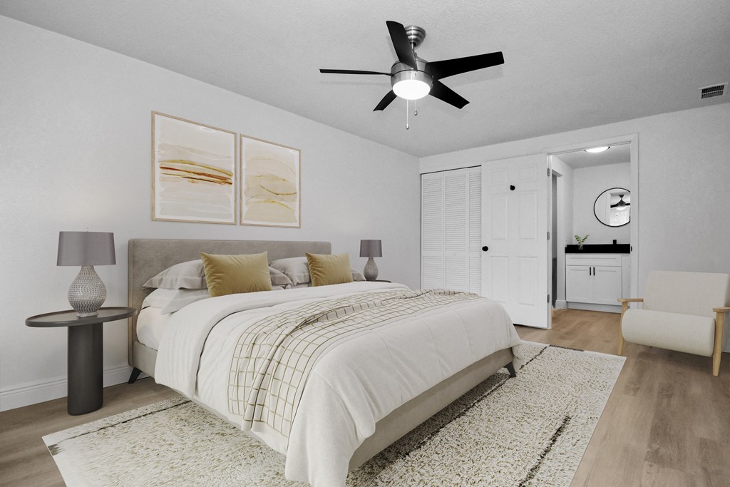 a bedroom with a large bed and a ceiling fan