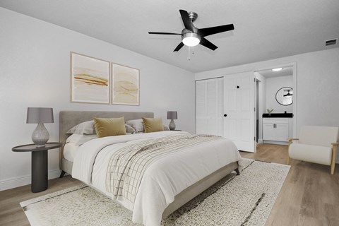 a bedroom with a large bed and a ceiling fan