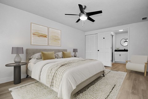 a bedroom with a large bed and a ceiling fan