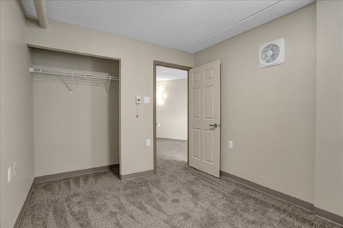 a bedroom with a closet and a door to a closet