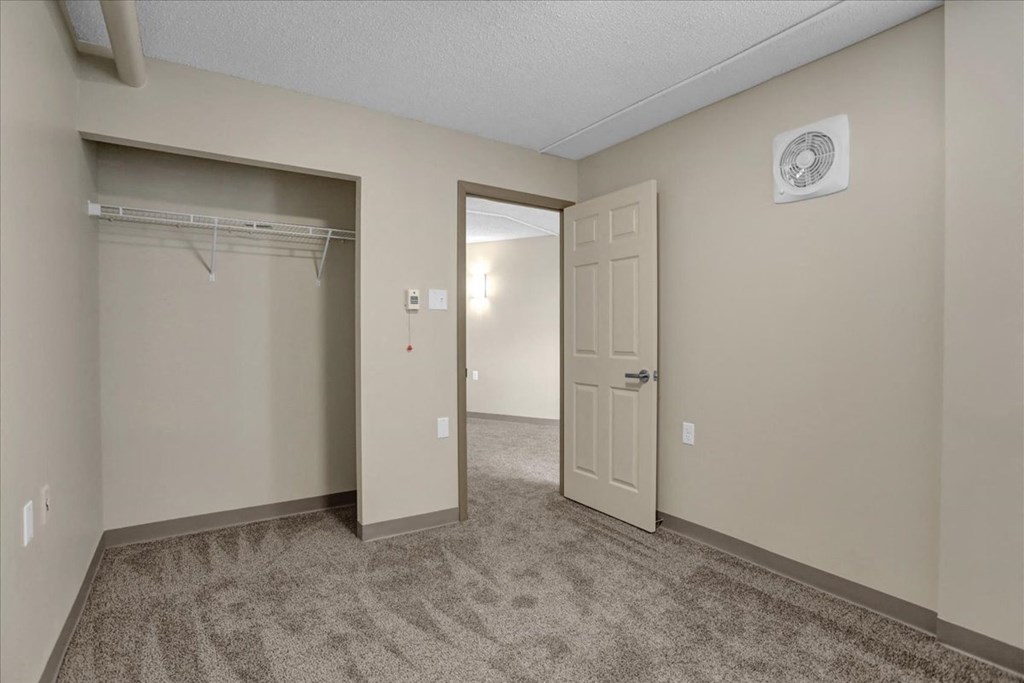 a bedroom with a closet and a door to a closet