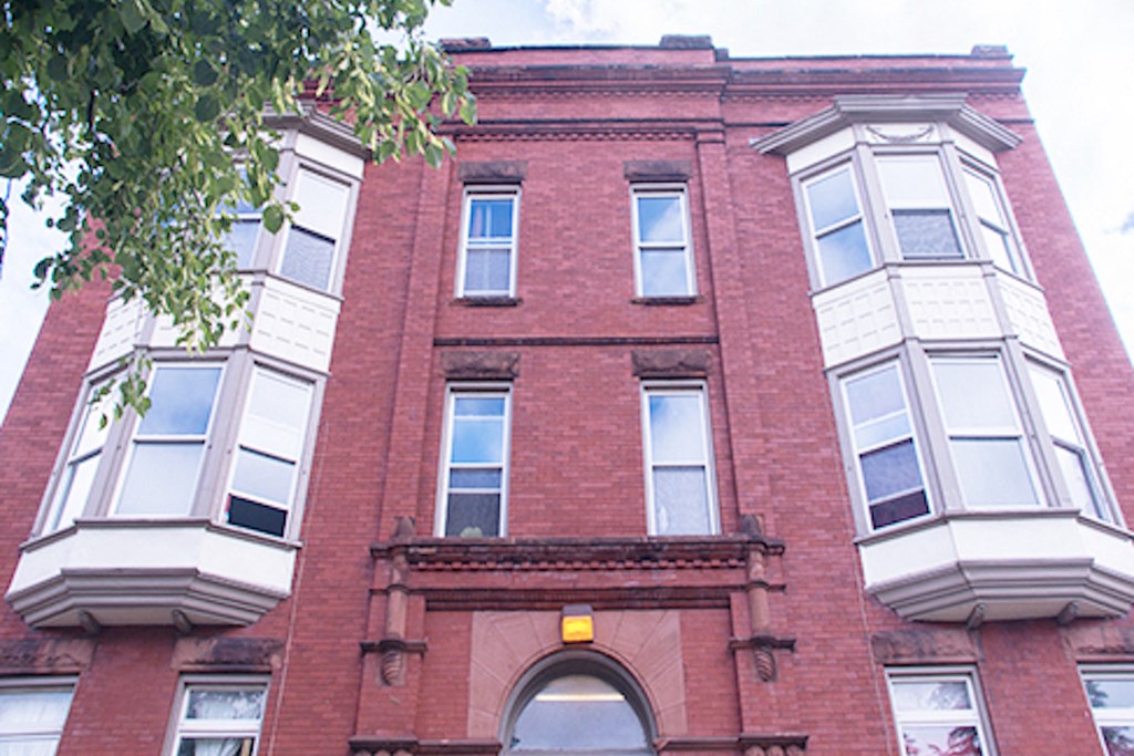 red brick apartment building with massive windows at 231 West Ave in Buffalo, NY