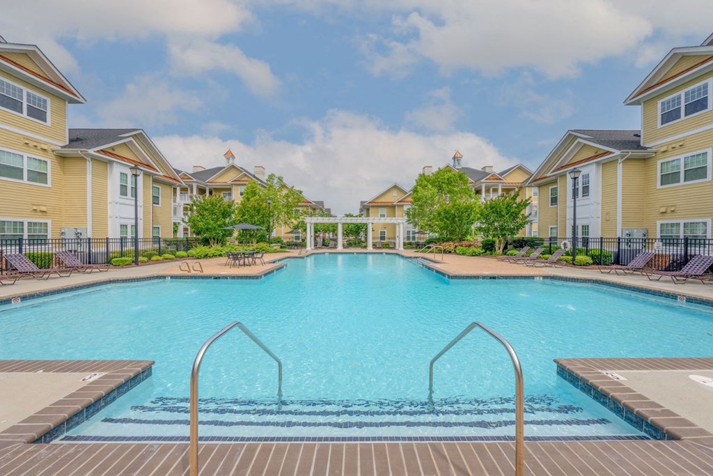 large swimming pool with handrails and stairs at Fenwyck Manor Apartments