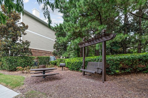 The picnic, grill, and swing area at Centerville Manor Apartments