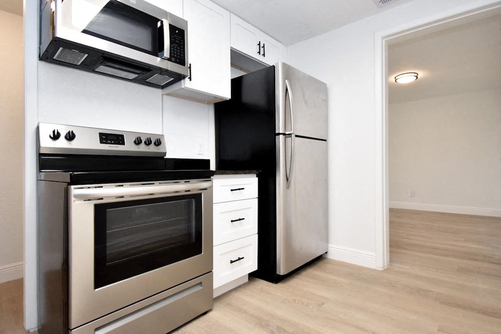 a kitchen with a stove and a refrigerator