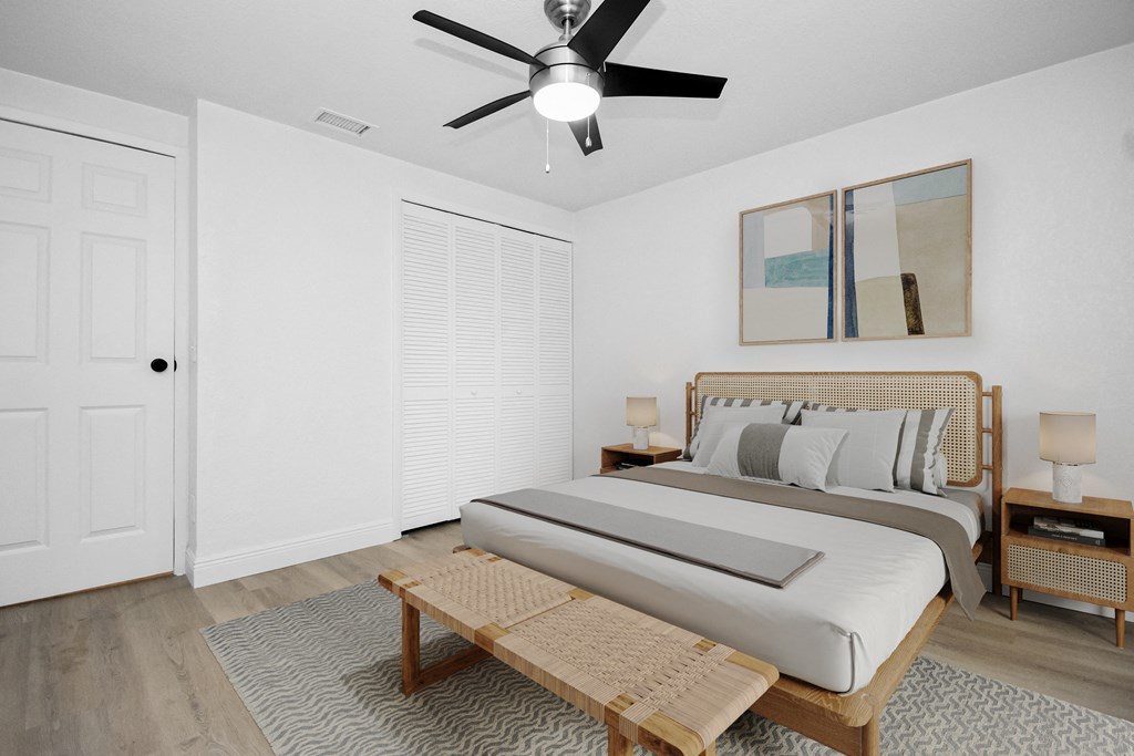 a bedroom with a bed and a ceiling fan