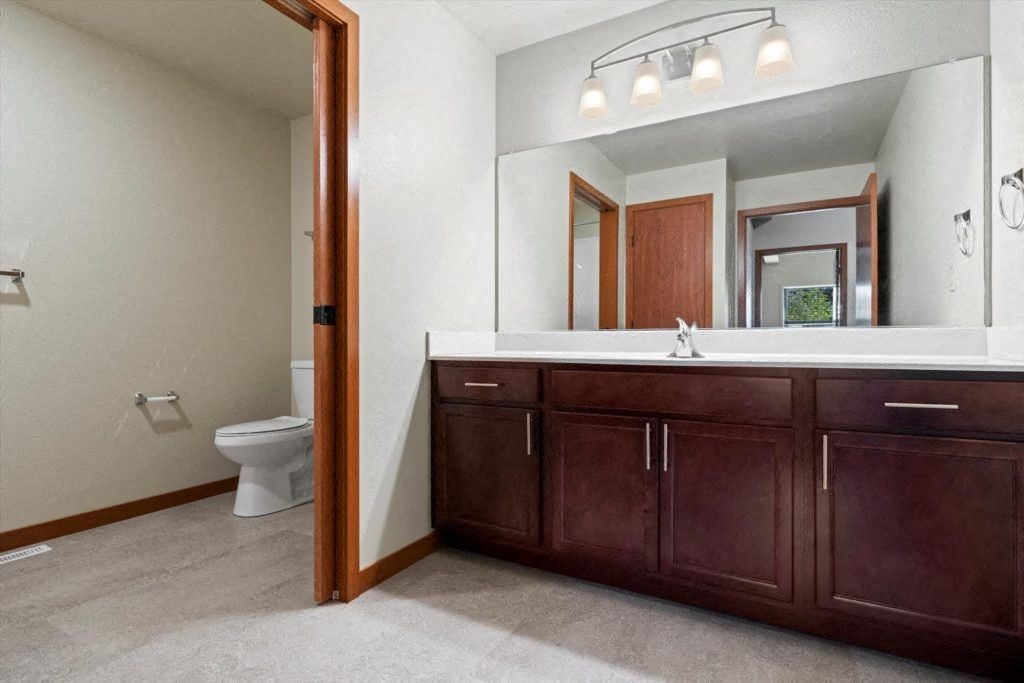 A Spartan Loft bathroom with a sink and a toilet and a mirror