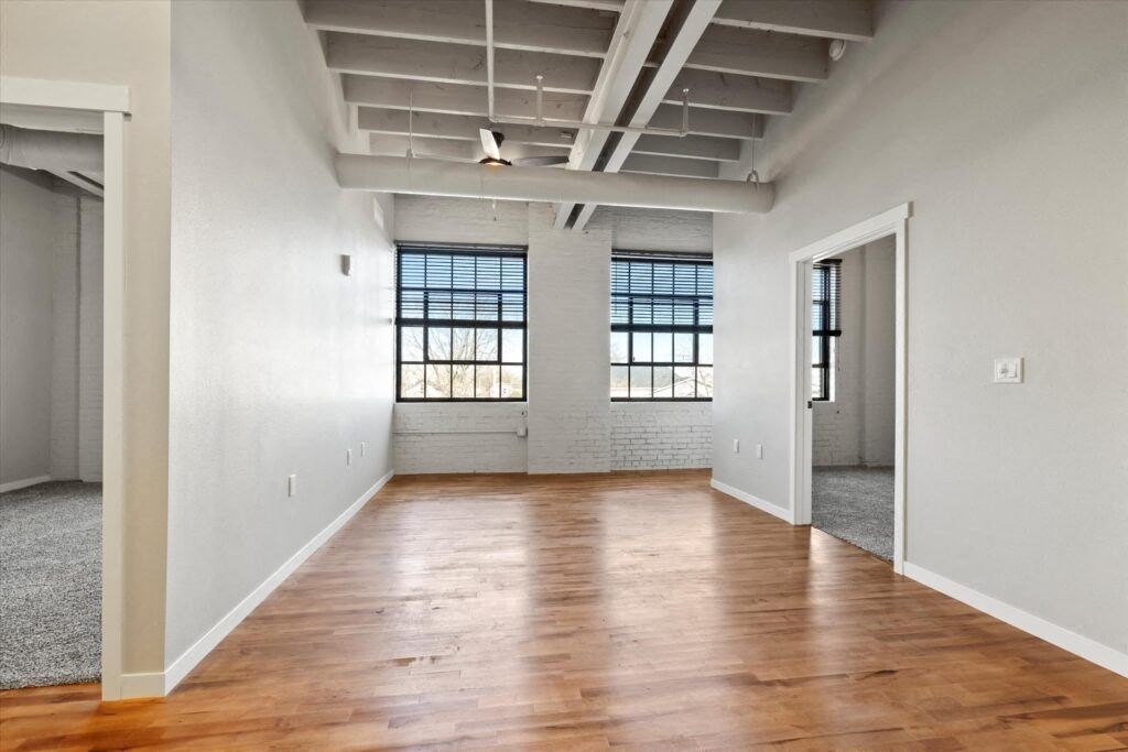 a living room with massive windows and high ceilings in an income-restricted Brooke Street Loft