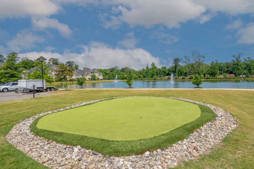 putting green with the pond in the background at Fenwyck Manor Apartments for rent