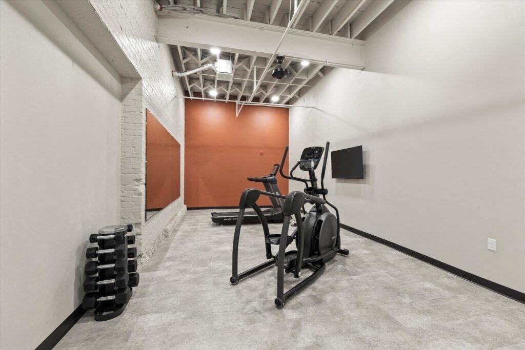 a fitness center with cardio and strength equipment