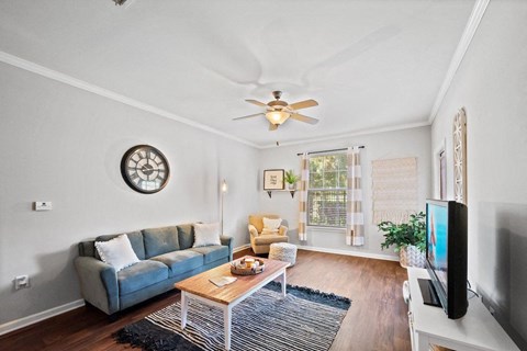 a Centerville Manor living room with a couch coffee table and a ceiling fan