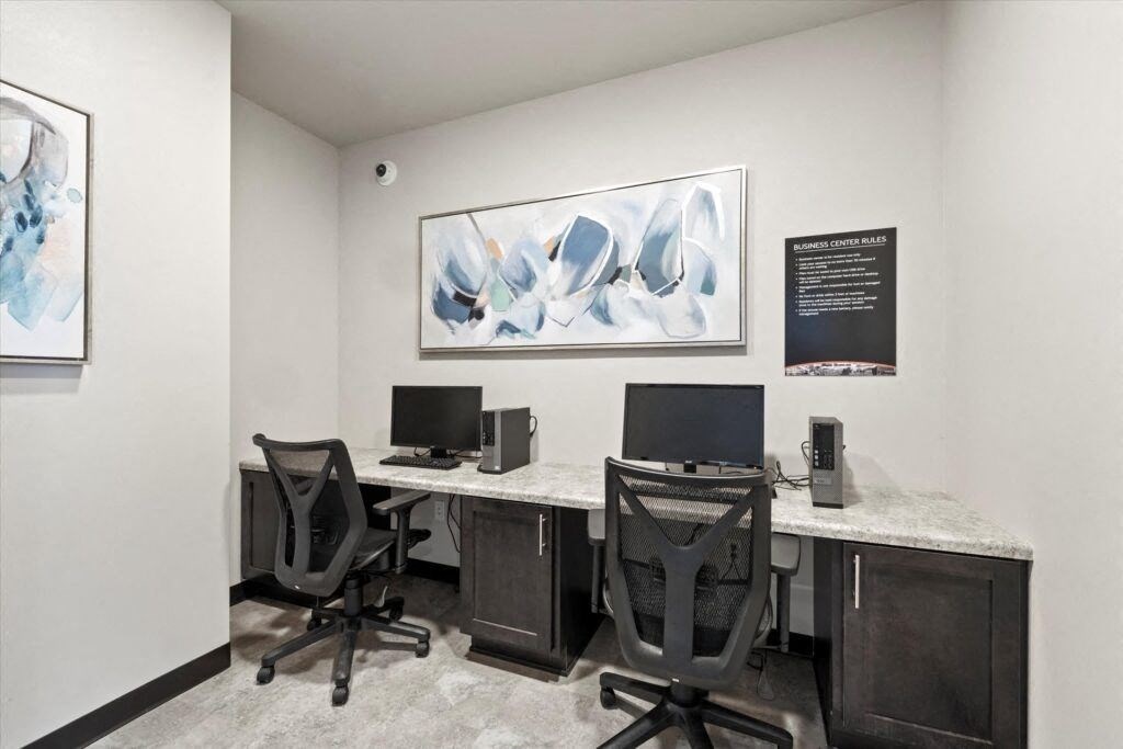two desks with computers in Brooke Street Lofts business center
