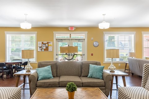 A living room with a grey couch and a coffee table.