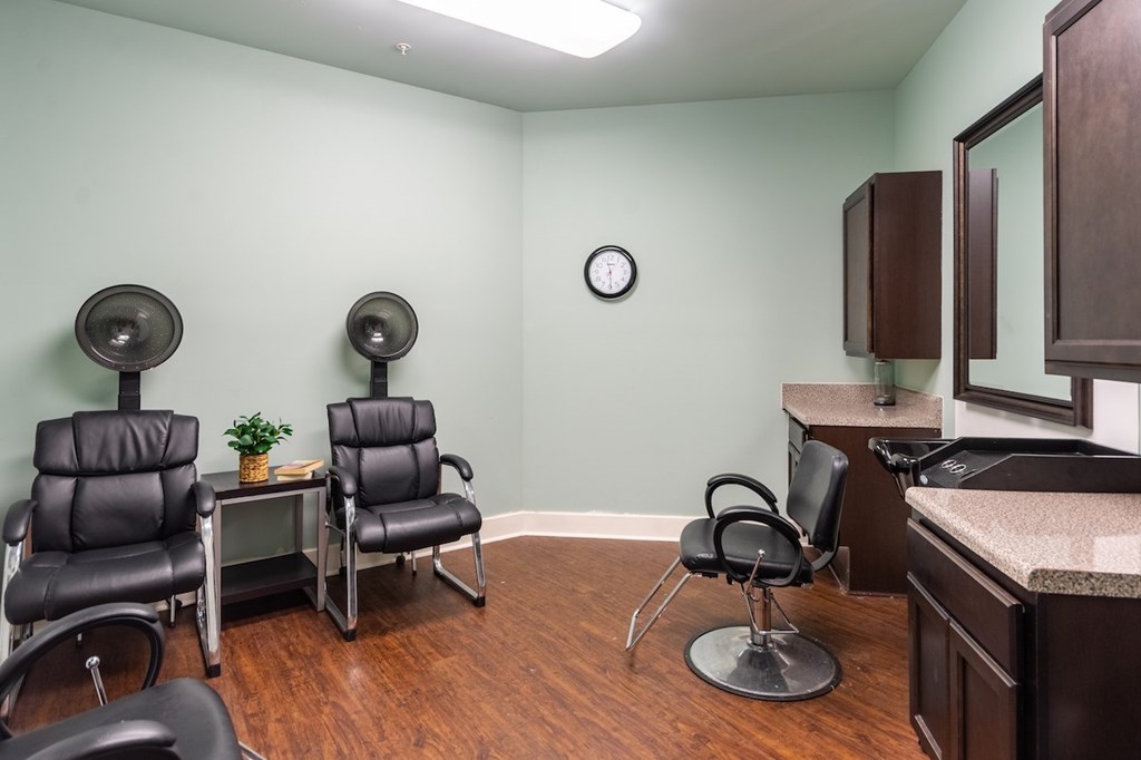 A room with a green wall and a clock on it.