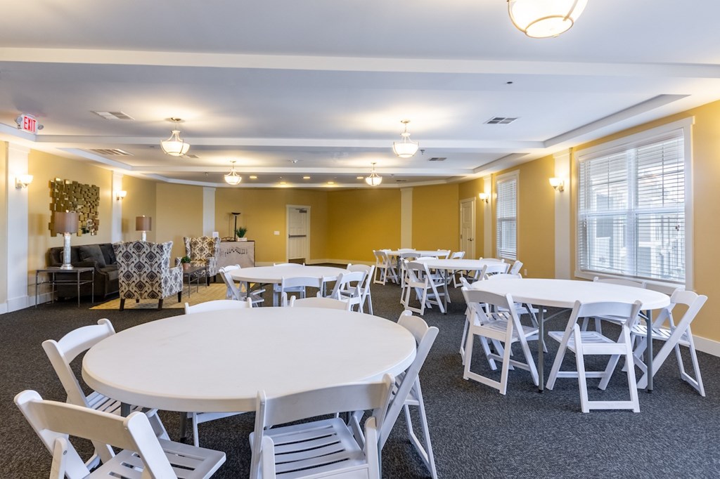 A room with tables and chairs is set up for an event.