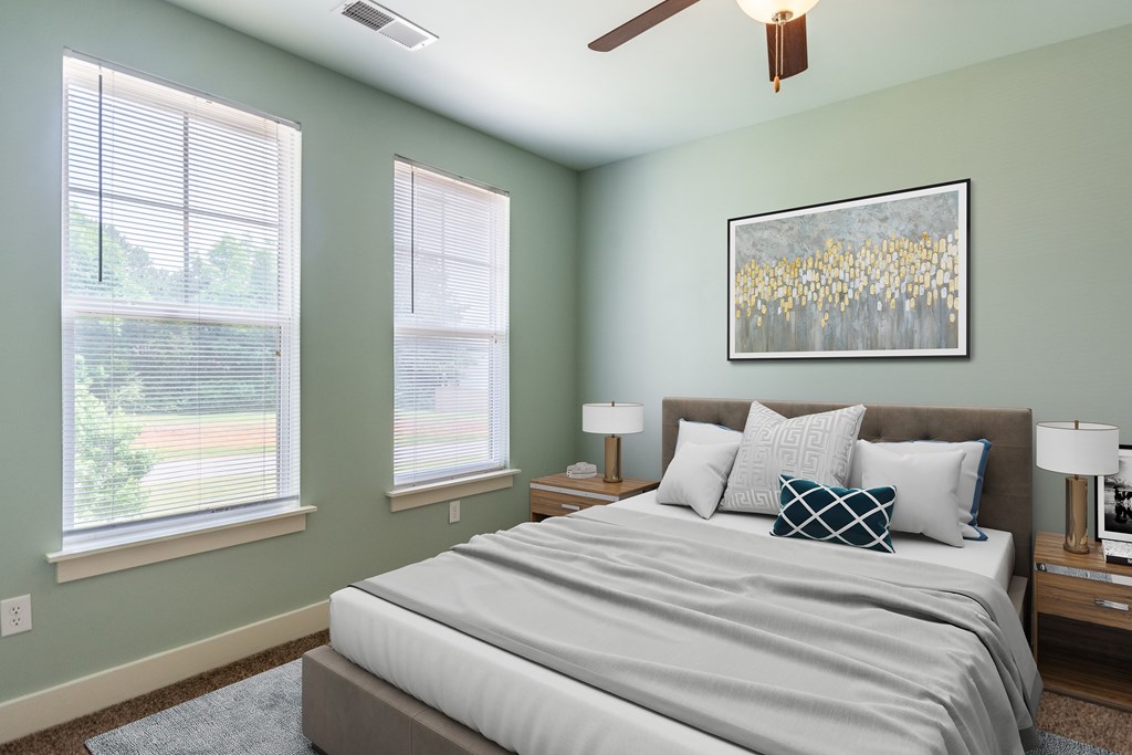 A bedroom with a bed, two lamps, and a painting on the wall.