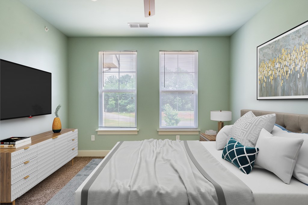 A bedroom with a bed, a dresser, and a television.
