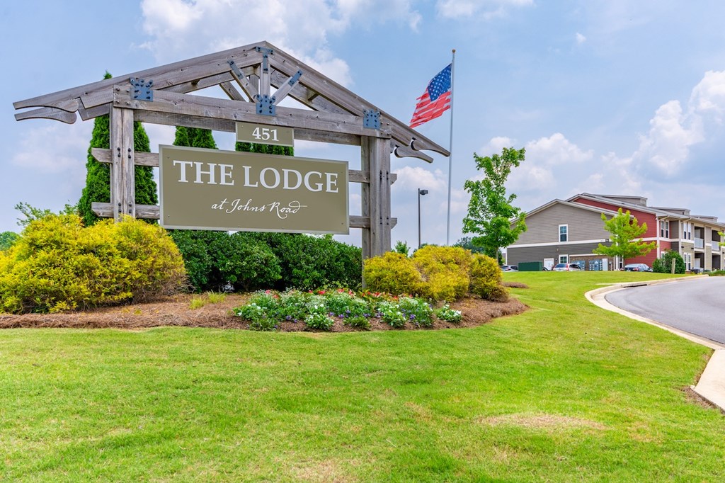 A sign for The Lodge stands in front of a building.