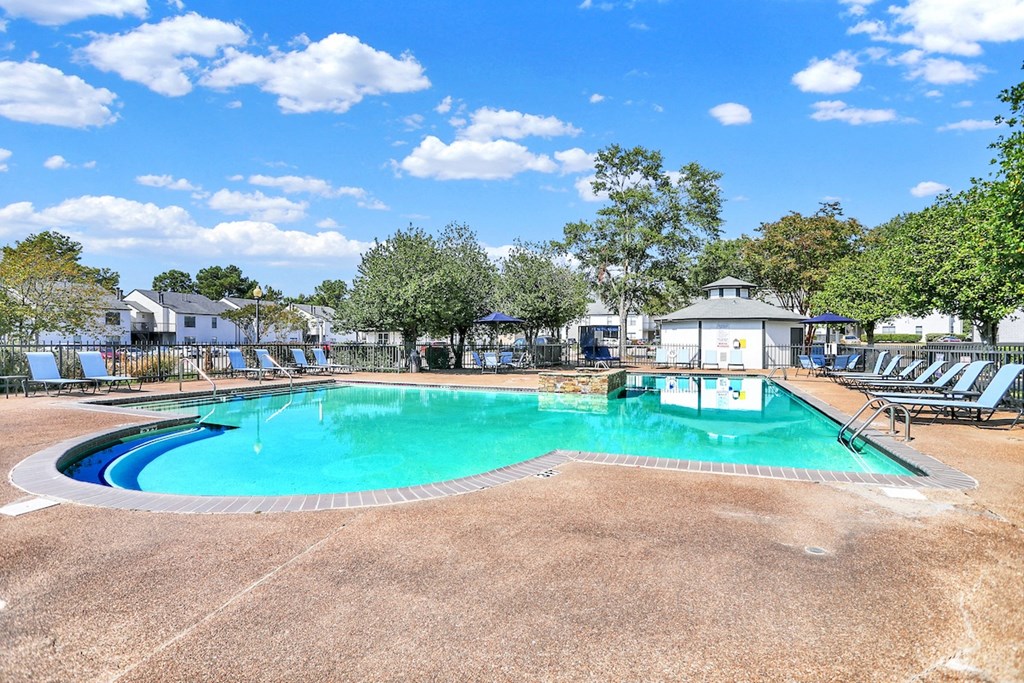 The large pool, new lounge chairs, and grilling stations at Rock Creek Apartments