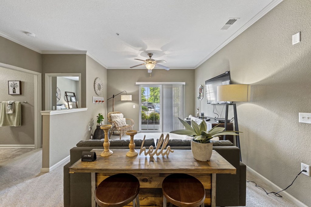 large living room with ceiling fan and model decor at Fenwyck Manor