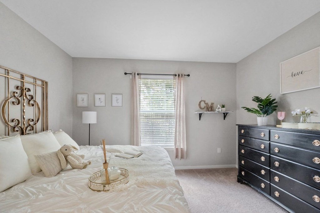 a bedroom with a large bed and a dresser