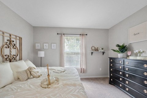 a bedroom with a large bed and a dresser