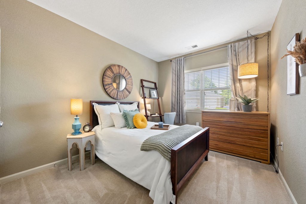 spacious bedroom with model decor and large window in Fenwyck Manor Apartment home